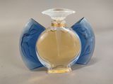 a blue glass bottle with a yellow liquid inside of it