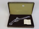 a gun in a box with a book in it