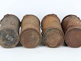 four old wooden barrels are lined up on a white surface