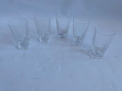 six glasses sitting on a table with a white background
