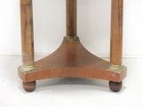 a small wooden table with a marble top on wheels