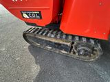 a red tractor that is parked on the side of the road