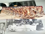 a picture of a group of naked people riding bicycles
