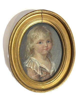 portrait of a young girl in a gold frame with blue eyes