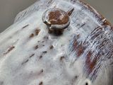 a close up of a ceramic object with a ring on it