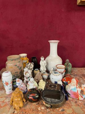 many different vases on a table with a red wall in the background