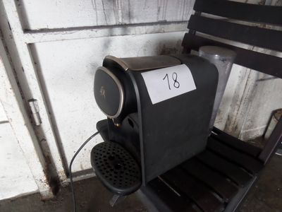 une chaise noire sur laquelle est posée une pancarte, à côté d'une autre chaise noire