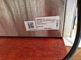 a label on the side of a stainless steel refrigerator