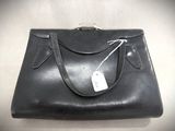 an image of a black purse with a price tag on it