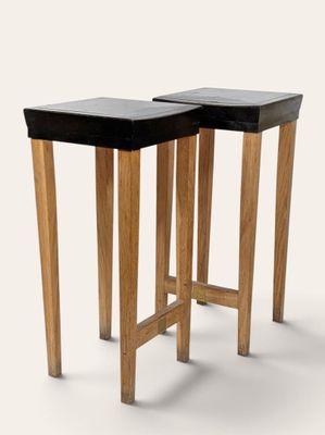 two wooden tables with black tops and legs on a white background