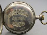 an old silver pocket watch sitting on top of a table