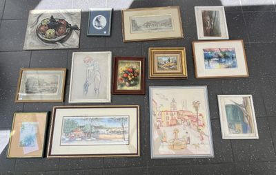 a lot of framed art on the floor of this room