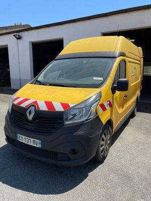 the yellow van is parked in front of a garage