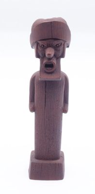 a wooden statue of a man with a hat on
