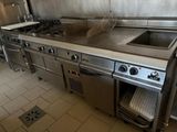 a large stainless steel kitchen with a sink and a stove