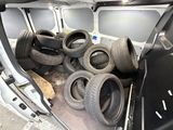 a lot of tires in the back of a van