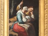 une peinture ancienne représentant une femme tenant un enfant sur ses genoux