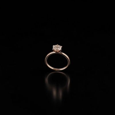 a close up of a diamond ring on a black surface