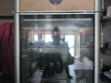a man taking a picture of himself in the reflection of a refrigerator