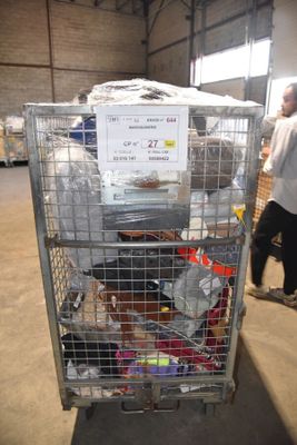 une cage métallique remplie d'une multitude d'objets dans un entrepôt