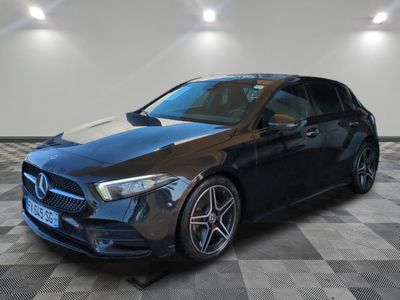 a black mercedes cla parked on a checkered floor