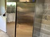 a large stainless steel refrigerator in the middle of a room
