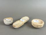 three small wooden bowls with labels on them sitting on a table