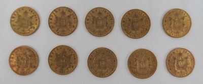 a close up of a group of coins on a white surface