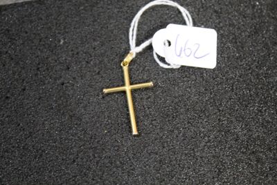 a cross on the ground with a price tag attached to it