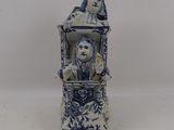 a blue and white vase with a man and a woman on it