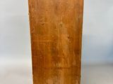 an old wooden box sitting on top of a white surface