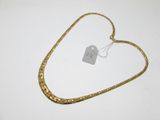 a close up of a gold chain with a tag on it