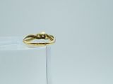 a gold ring sitting on top of a clear glass