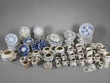 many different types of blue and white dishes and cups