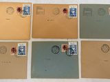 six different envelopes with stamps on them sitting on a table