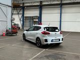 a white car parked in a parking lot near a building