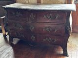 a wooden chest of drawers sitting on a hard wood floor