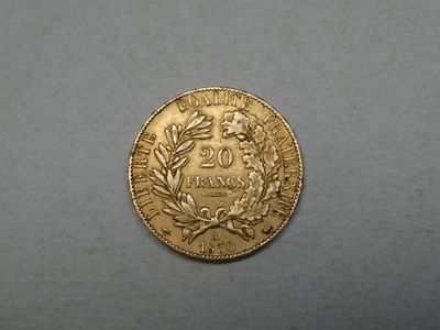 a close up of a gold coin on a gray surface