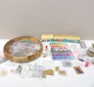 a table with a bowl of beads and other crafting supplies