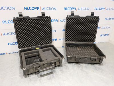 two black cases are sitting next to each other on a table