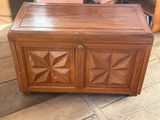 a wooden chest sitting on the floor in a room