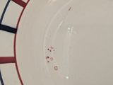 a white plate with red and blue stripes on it