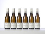six bottles of white wine lined up in a row