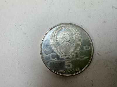 a silver coin with a picture of a woman on it