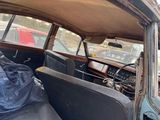 an old car that is parked on the side of the street
