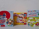 several games are lined up in a row on a table