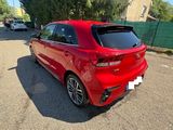 the rear end of a red car parked in a parking lot