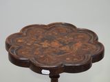 a small wooden table with a floral design on it