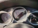 a close up of a car dashboard with a speedometer and gauges