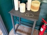 a small table with candles and a fire extinguisher on it